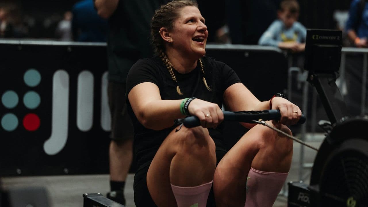 An athlete deep into a rowing effort at a TYRUN station