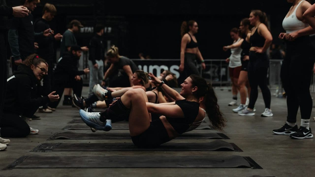 Athletes working through a floor station at a TYRUN race while others wait their turn